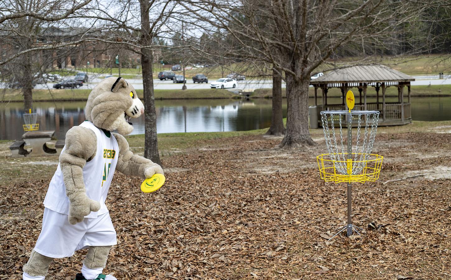 Bob the Bobcat throwing a disc into a basket